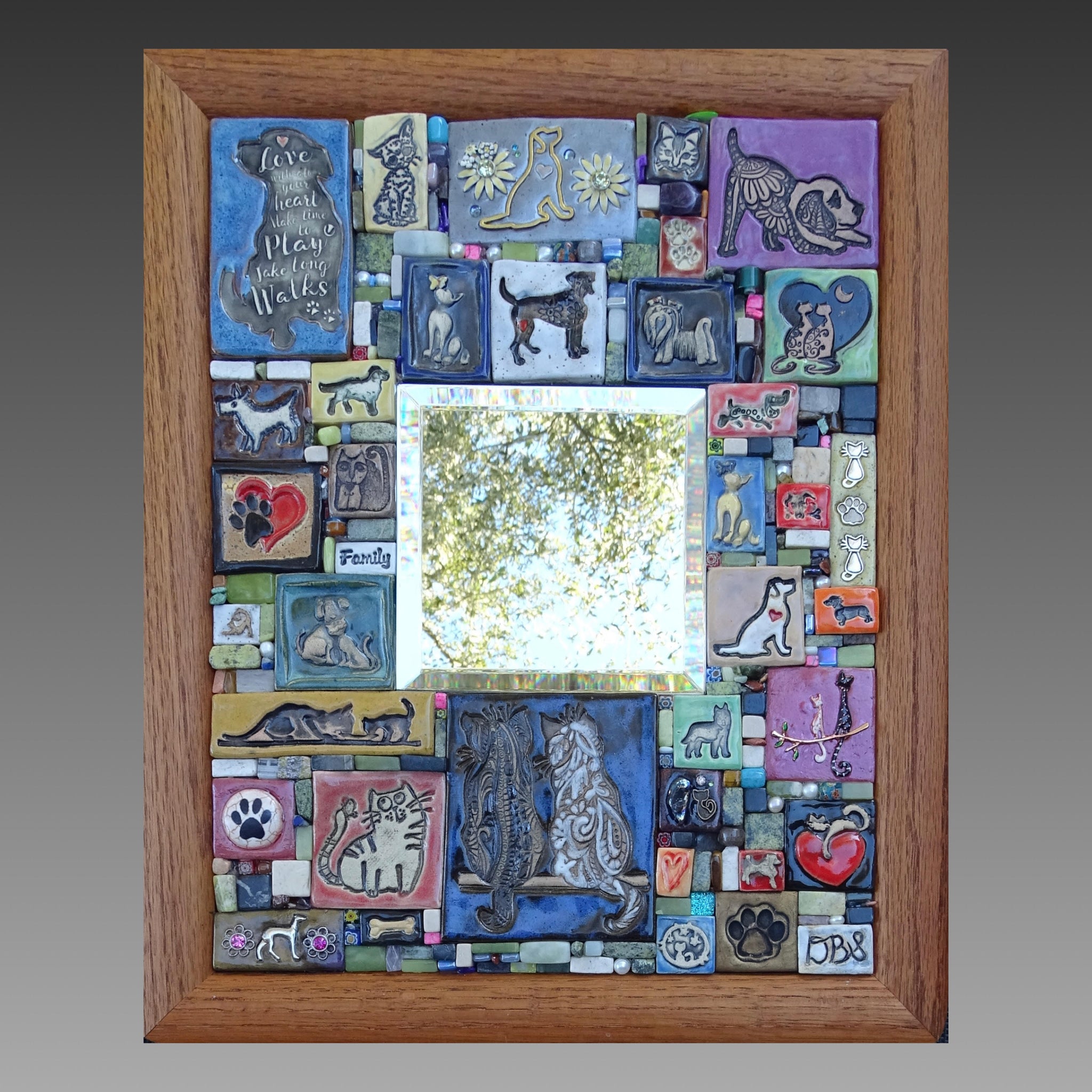 Mosaic pet-themed artwork with dogs, cats, hearts, and pawprints 